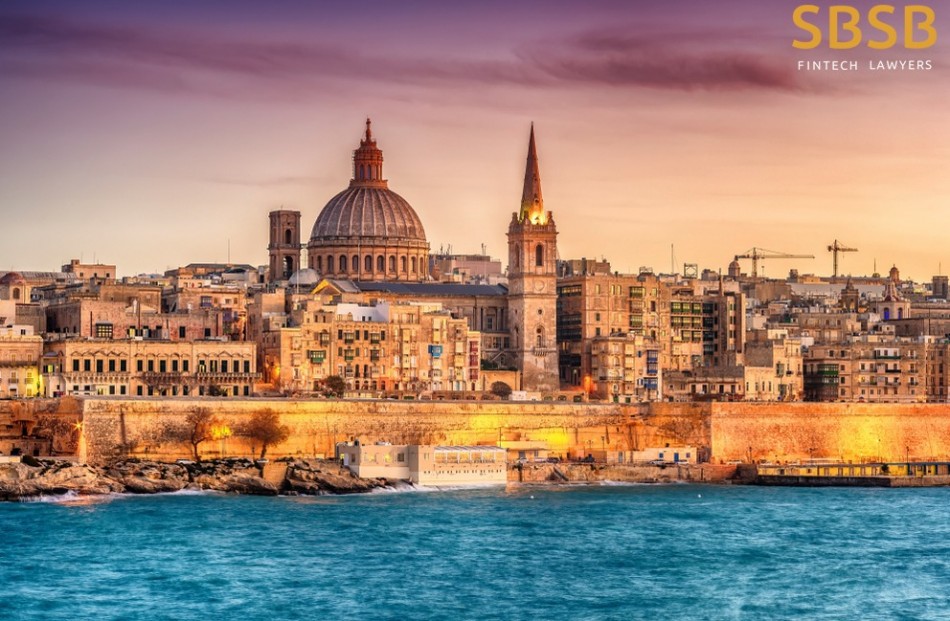 Coastal view of Valletta, Malta, highlighting historic buildings and notable dome structure at sunset.