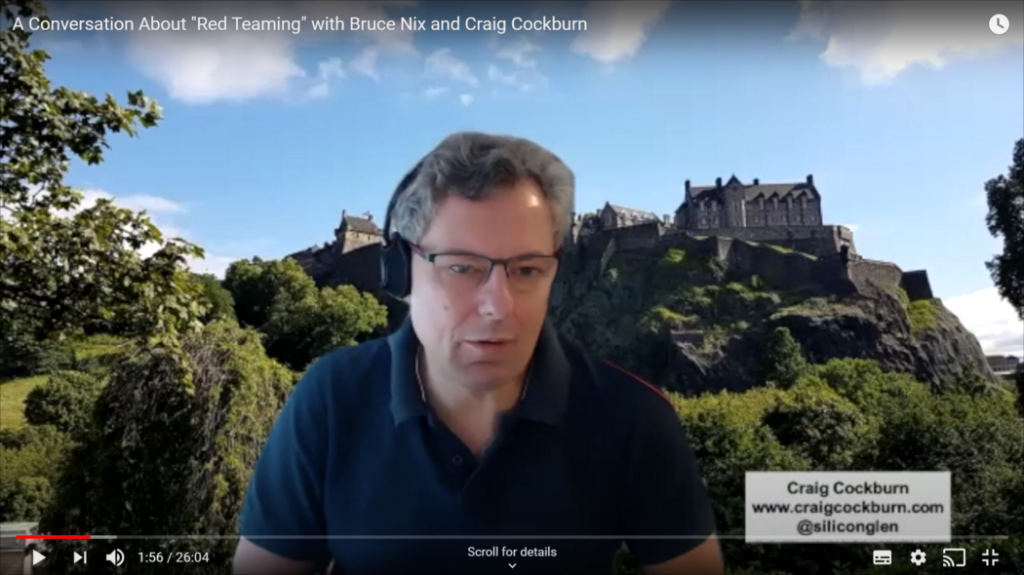 Two individuals discussing cybersecurity strategy, with Edinburgh Castle visible in the background.