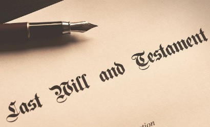 Last will and testament document with a fountain pen resting on top.