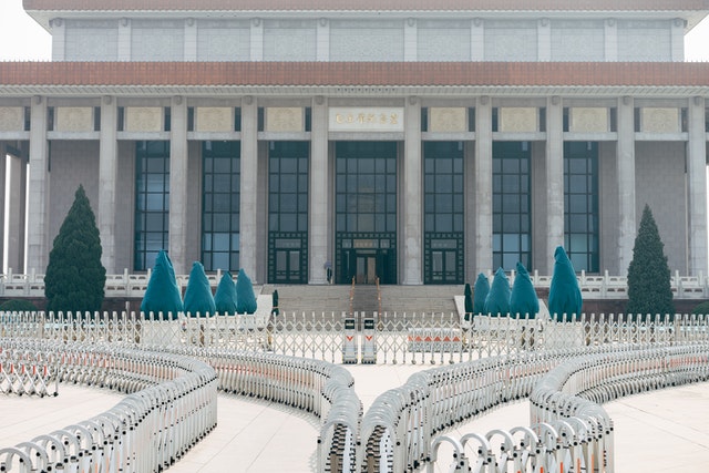 Government building with grand architecture, surrounded by bicycle racks and trees, indicating a civic location.