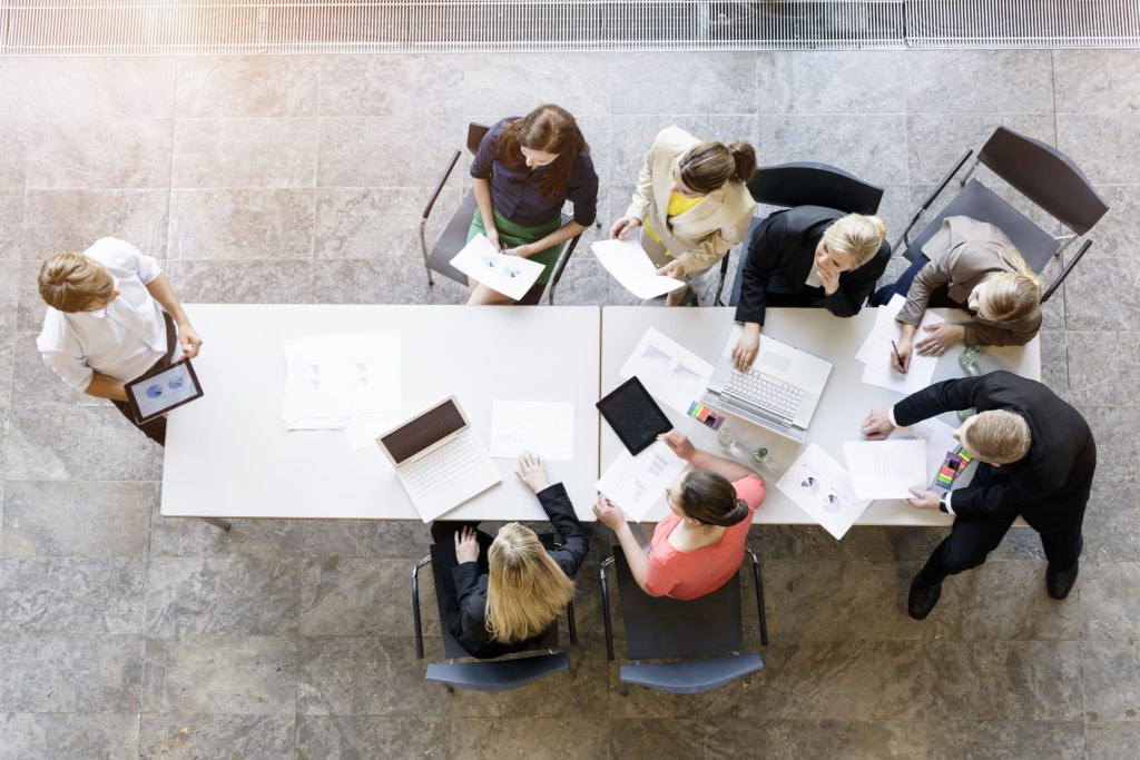 Lawyers in a meeting collaborating and reviewing legal documents at a conference table in a modern office setting.