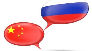 Speech bubbles with flags of China and Russia, representing communication or dialogue between the two countries.