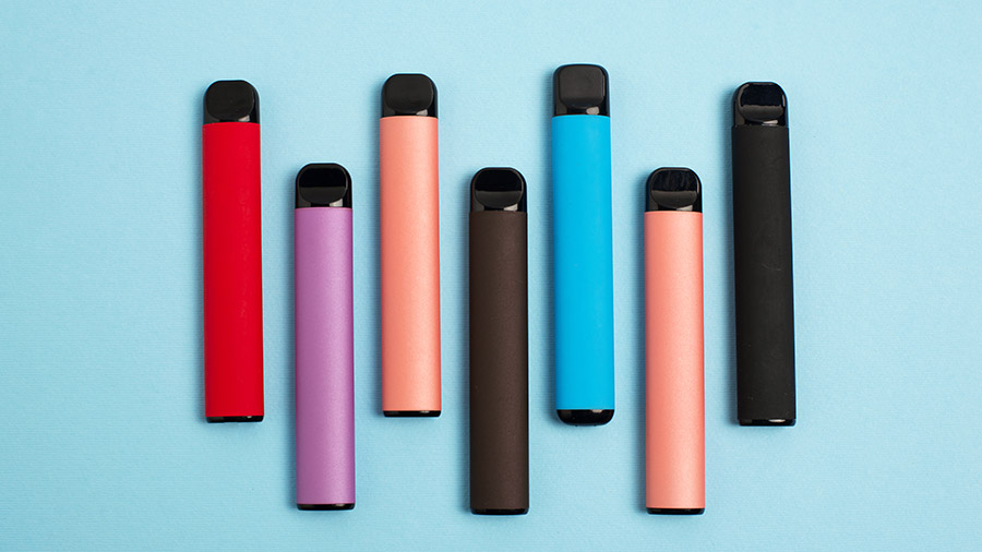 Eight vapes in various colors arranged on a light blue background.