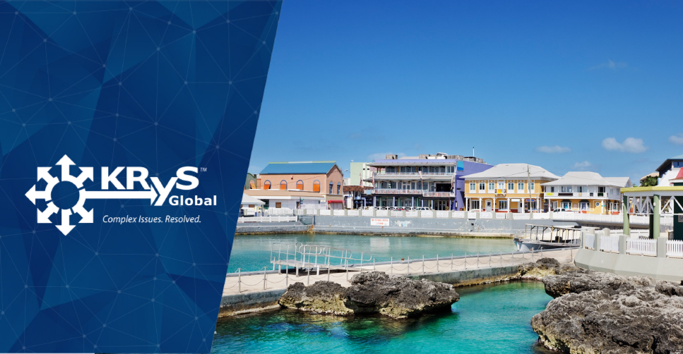 Coastal waterfront view featuring colorful buildings and a clear blue sky.