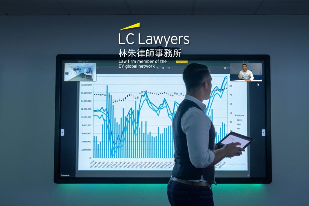 Lawyer presenting financial data on a screen during a virtual consultation in a modern office.