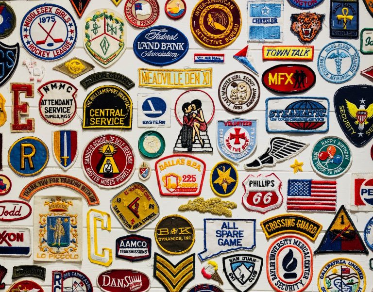 Collection of various embroidered patches displaying logos and symbols from different organizations and services.