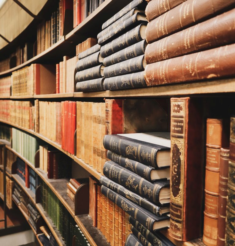Bookshelves filled with various legal texts and volumes in a law library setting.