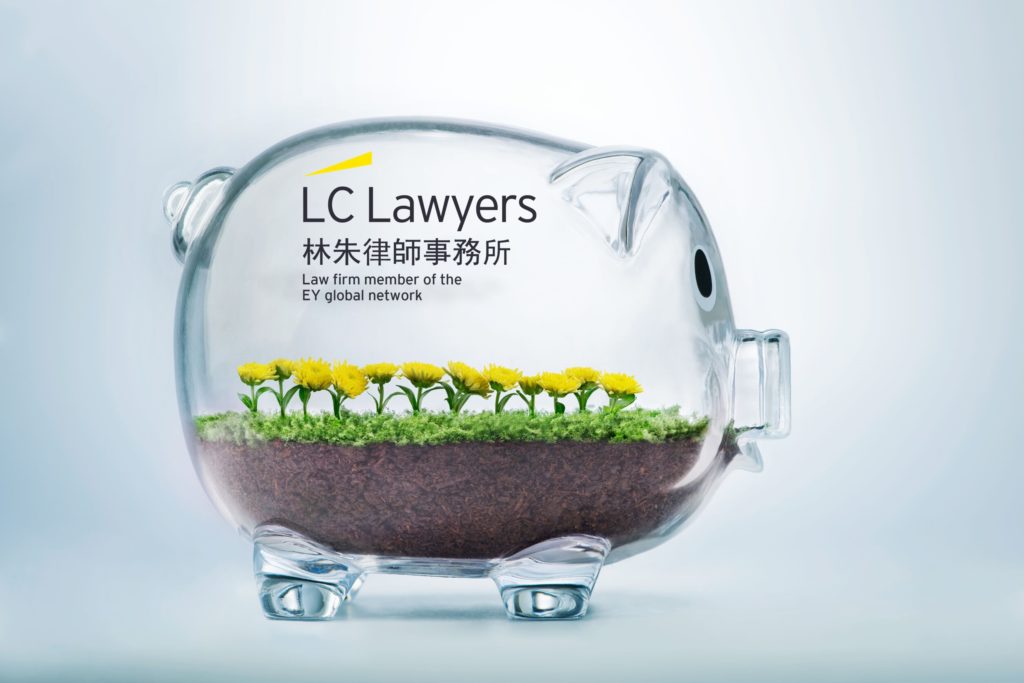 Glass piggy bank with flowers and soil, featuring LC Lawyers branding and EY global network affiliation.