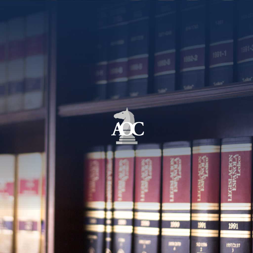 Law books arranged on shelves featuring a logo depicting a chess piece.