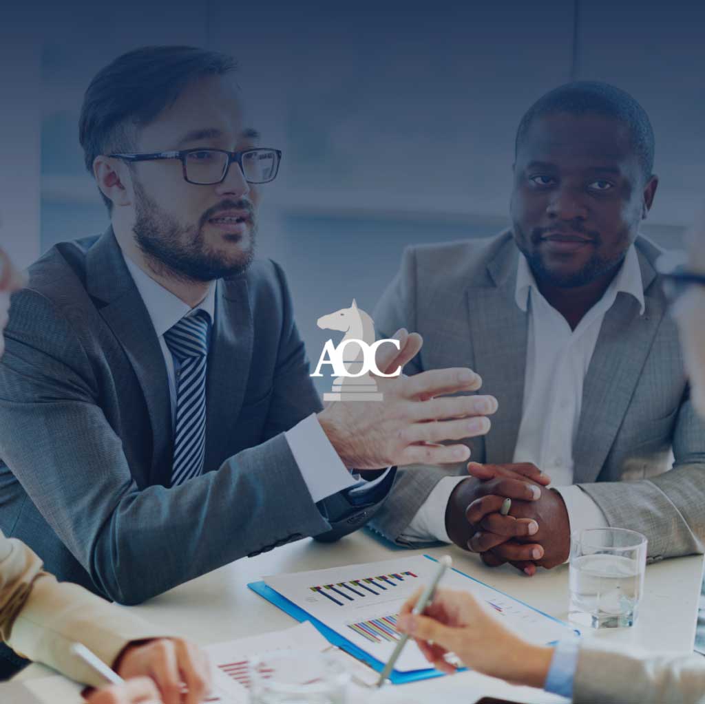 Lawyers discussing strategies at a conference table with documents and charts in a modern office setting.