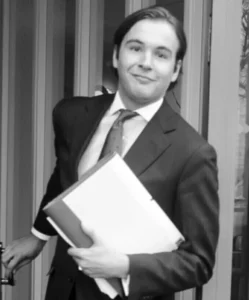 Lawyer exiting a building while holding a stack of legal documents.