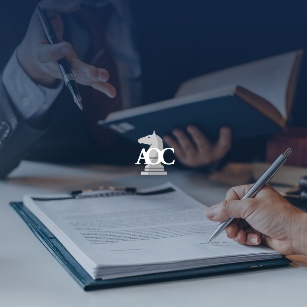 Lawyer gesturing while reviewing legal documents with another person in a professional office setting.