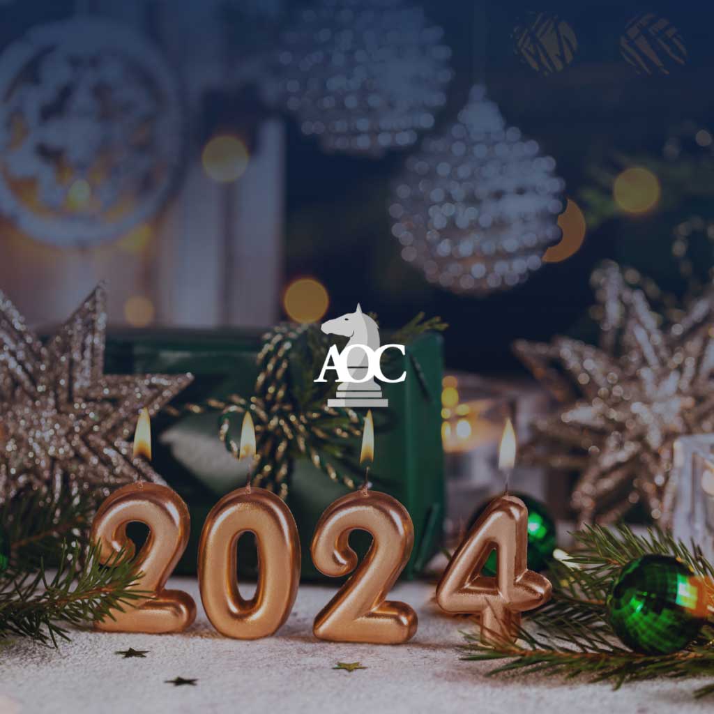 Candles shaped as "2024" with festive decorations and greenery, set amidst a holiday-themed background.