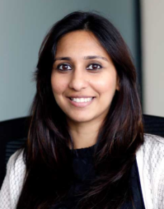 Legal professional smiling at the camera, seated in an office environment.