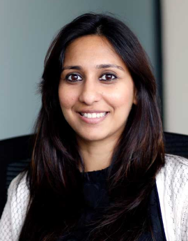 Legal professional smiling at the camera, seated in an office environment.