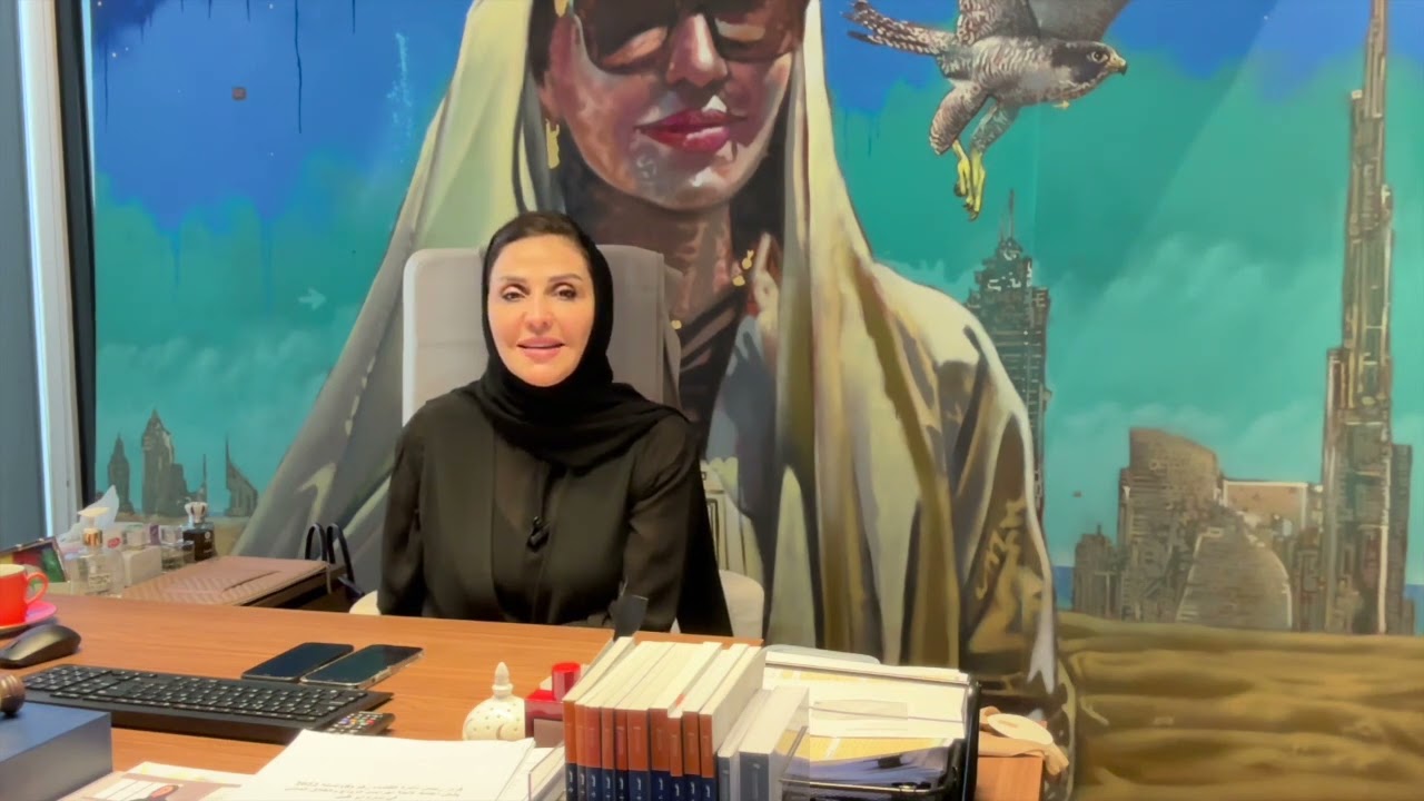 Lawyer sitting at desk in office, with legal books and artwork featuring a skyline backdrop.