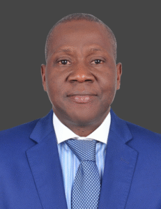 Lawyer wearing a blue suit and patterned tie, posing for a professional headshot against a gray background.
