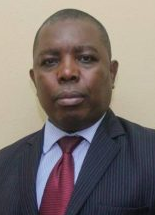 Legal professional in a suit, looking directly at the camera against a neutral background.