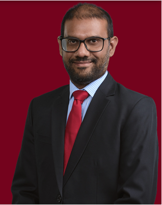 Lawyer in formal attire smiling against a red background.