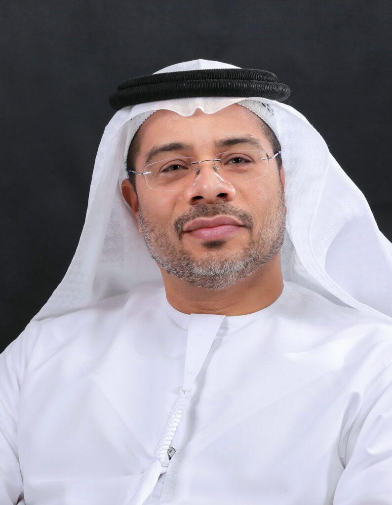 Legal professional in traditional attire, facing the camera, presenting a confident expression against a dark background.