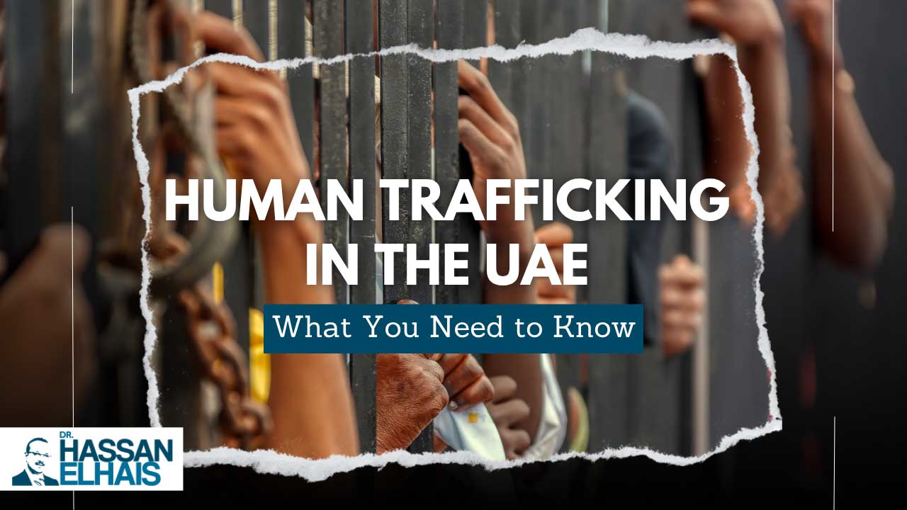 Hands reaching through bars, highlighting the issue of human trafficking in the UAE.