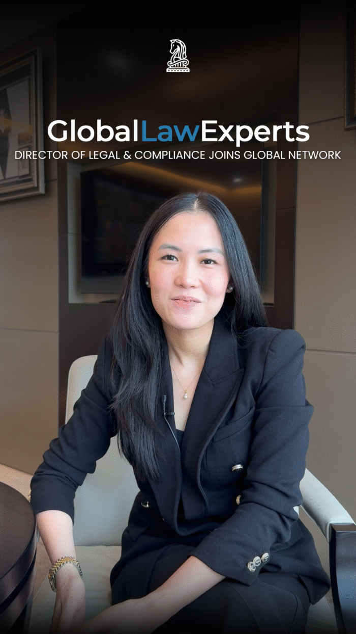 Director of legal and compliance speaking in a modern office setting.