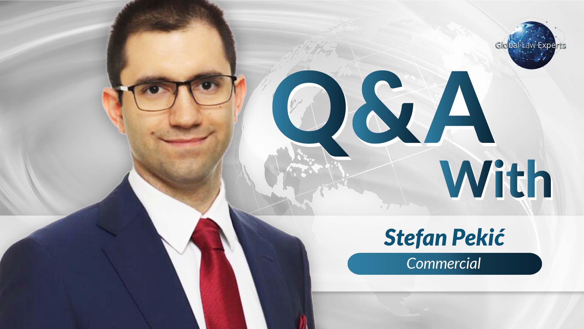 Commercial lawyer posing for an interview, wearing a suit with a global map background.