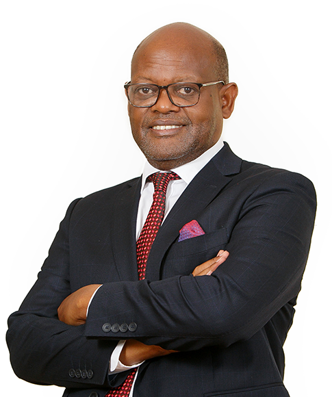 Attorney smiling confidently with arms crossed, wearing a suit and glasses, against a plain background.