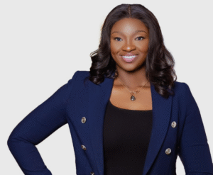 Lawyer smiling confidently while wearing a professional blazer against a neutral background.