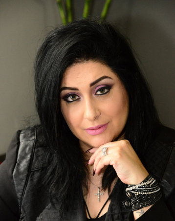 Lawyer posing thoughtfully with a hand on chin, seated in an office setting.