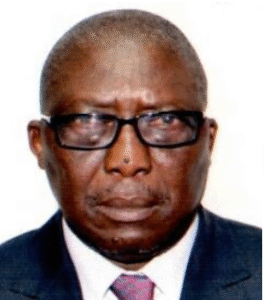 Legal professional in a suit and glasses, looking directly at the camera against a plain background.