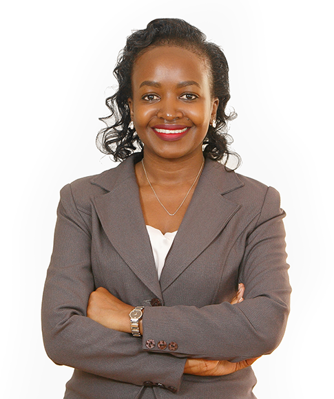 Smiling attorney with arms crossed, wearing a gray suit and standing against a neutral background.