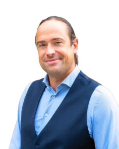 Lawyer in professional attire smiling against a plain background.