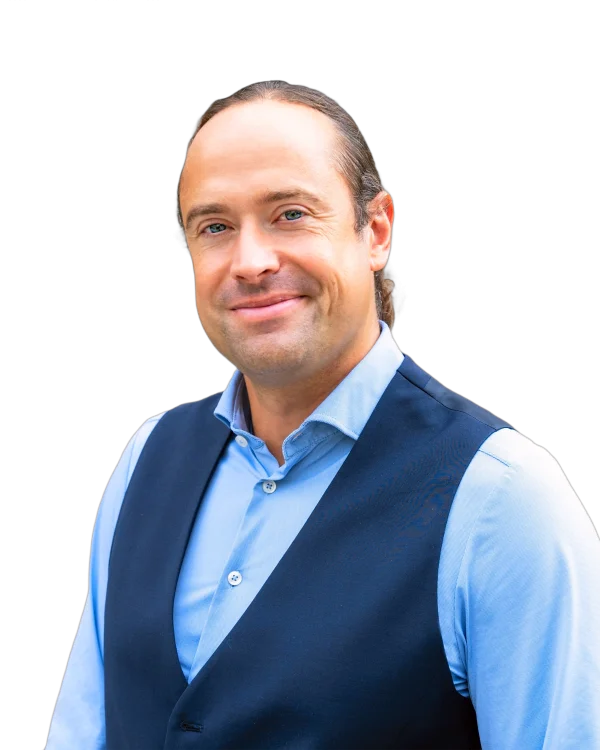 Lawyer in professional attire smiling against a plain background.