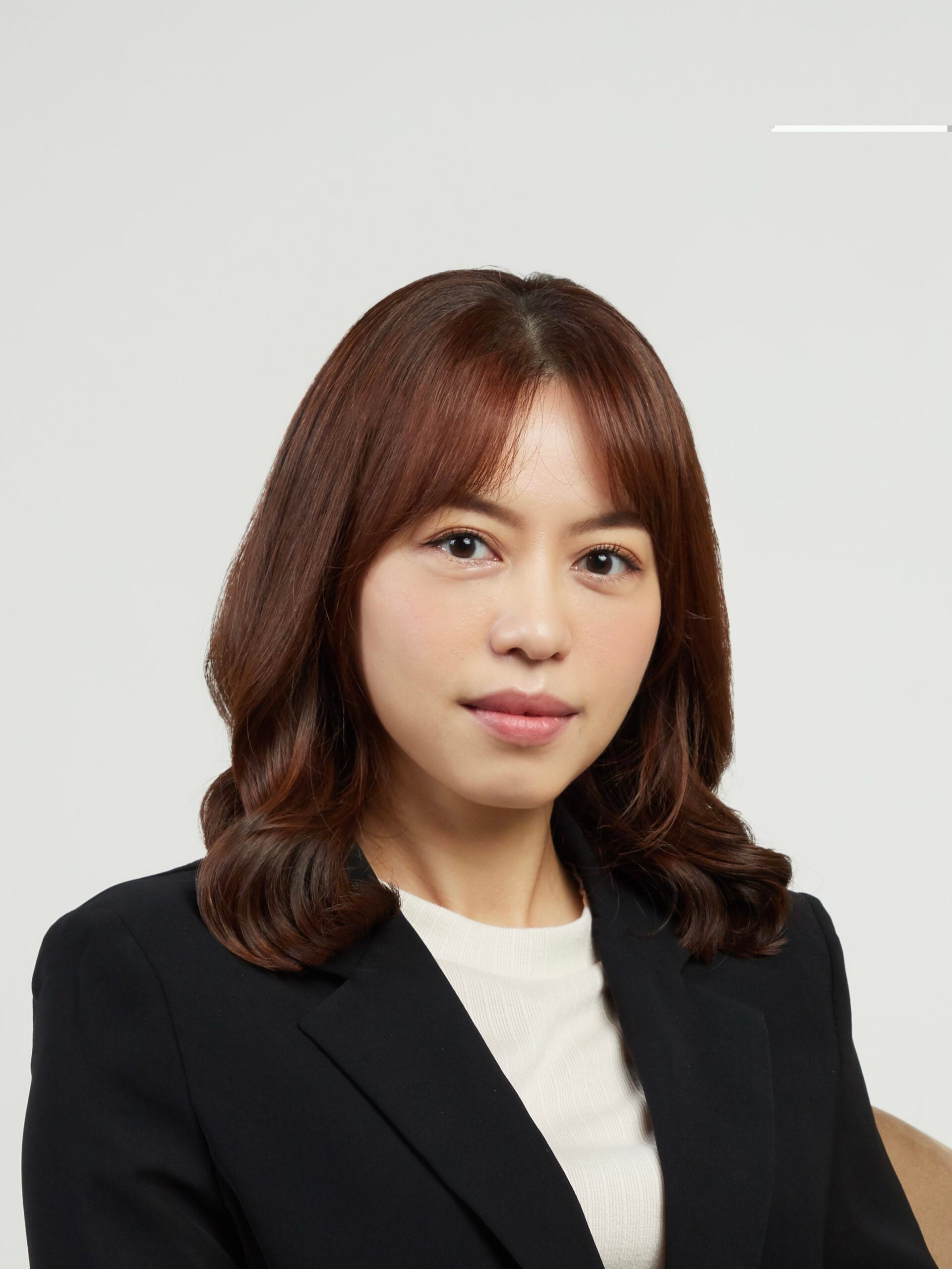 Attorney posing for a professional headshot, wearing a suit against a neutral background.