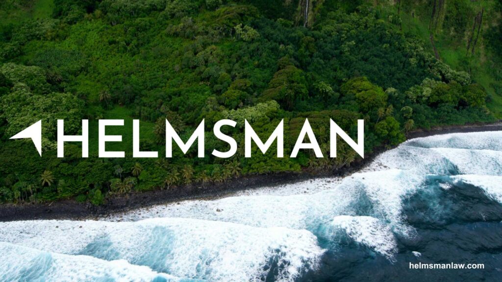 Coastal landscape with waves crashing on rocks and lush greenery, featuring the "HELMSMAN" logo prominently.