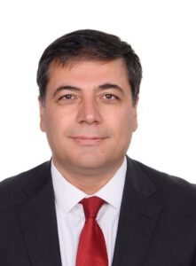 Male lawyer in a suit with a red tie, presenting a professional profile for legal directory.