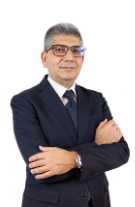 Lawyer standing confidently with arms crossed, wearing a suit and glasses, posing against a white background.