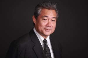Attorney in business attire posing against a neutral background