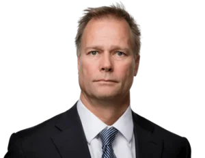 Legal professional in a suit, looking confidently at the camera in a neutral setting.