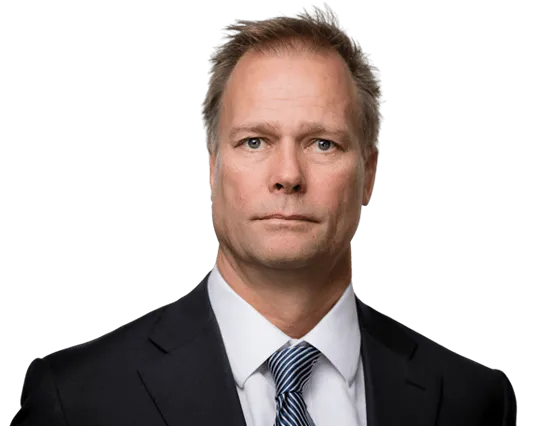 Legal professional in a suit, looking confidently at the camera in a neutral setting.