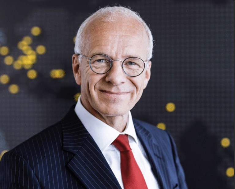 Lawyer smiling confidently in a pinstripe suit against a blurred background with abstract lights.