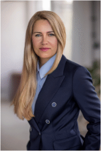Lawyer in professional attire posing confidently in an office setting.