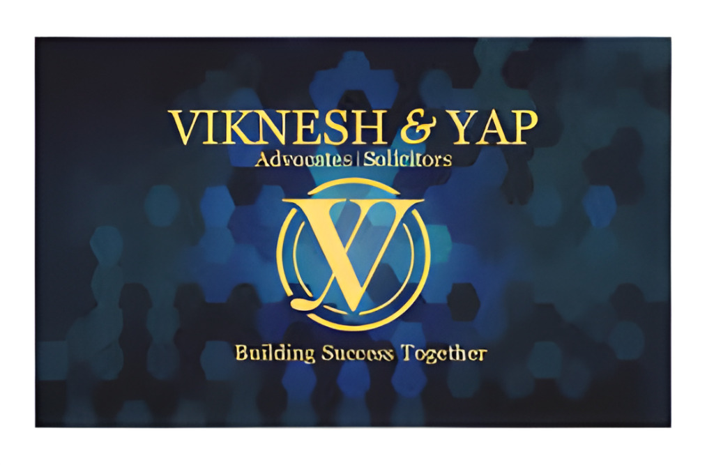 Blue And Gold Logo Of Viknesh &Amp; Yap Advocates And Solicitors With The Tagline &Quot;Building Success Together.&Quot;