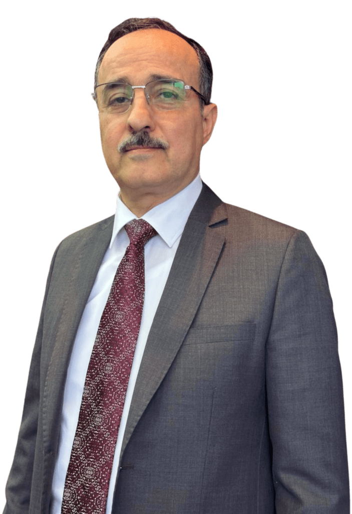 Lawyer in a suit, standing confidently with a neutral expression against a plain background.