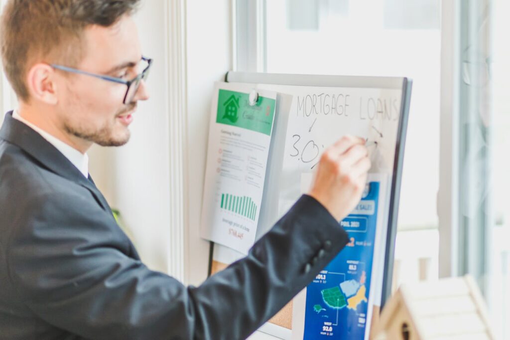 Lawyer writing financial information on a whiteboard in a professional office setting.