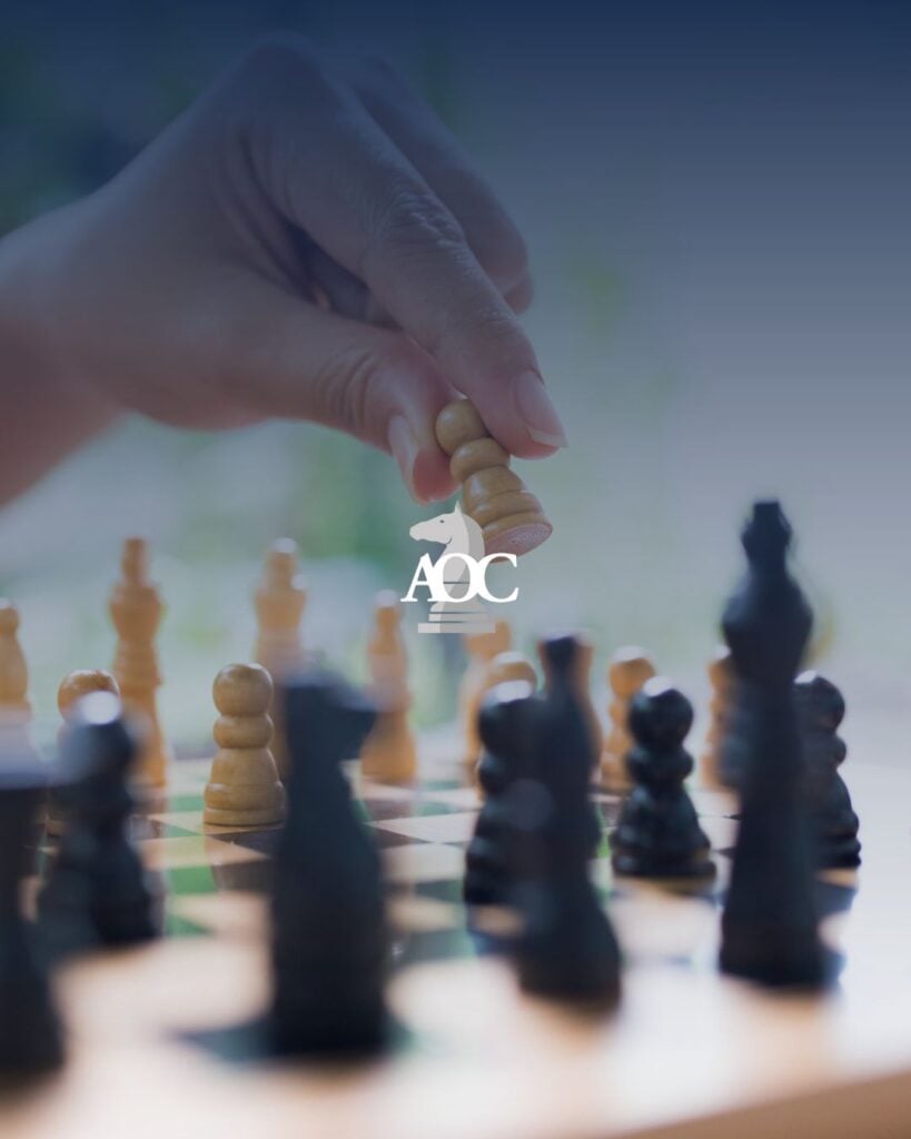 Hand moving a chess piece during a game, symbolizing strategy and critical thinking in a legal context.
