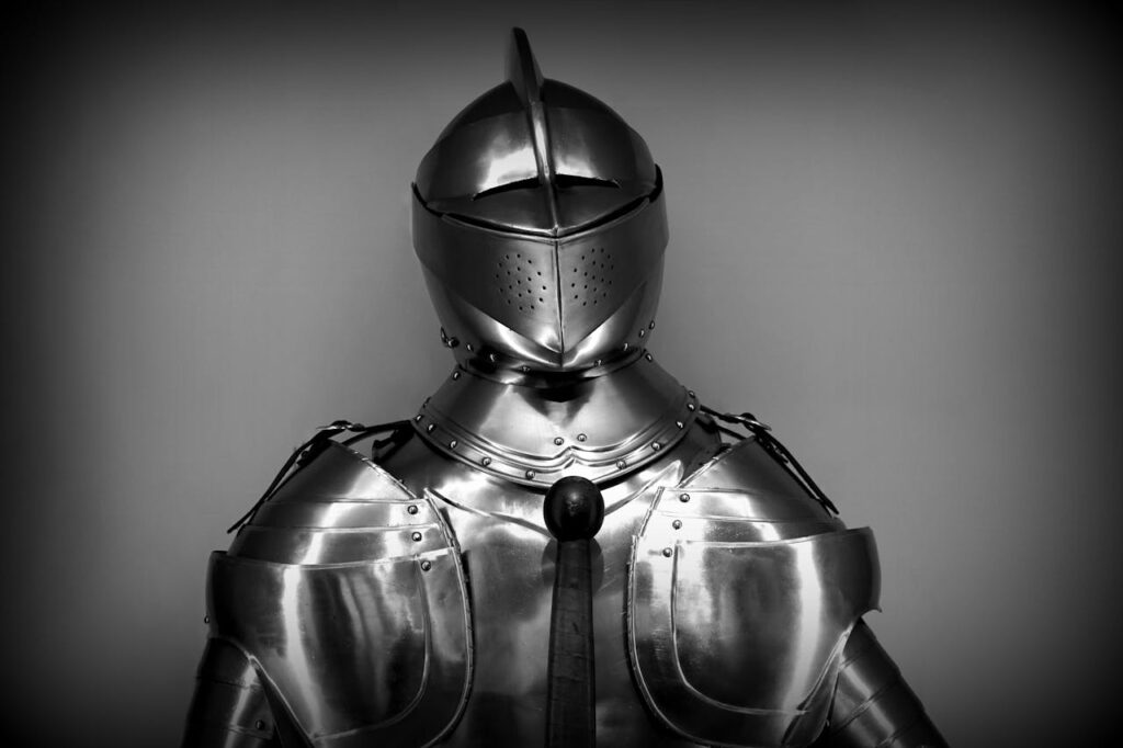 Medieval suit of armor displayed against a plain background, representing historical legal traditions.
