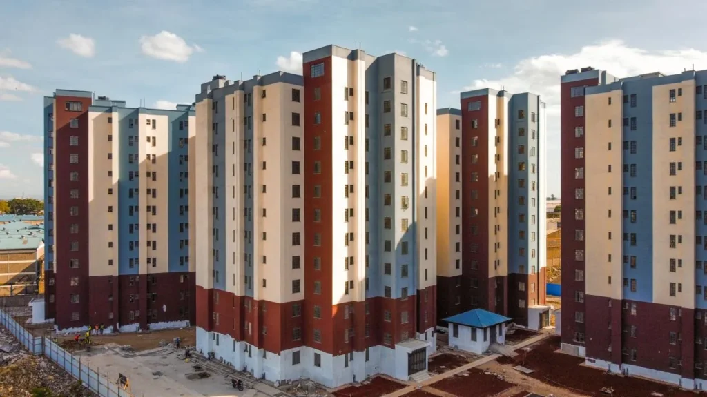 Multi-story residential buildings in a construction phase, featuring a mix of colors and unfinished landscaping.